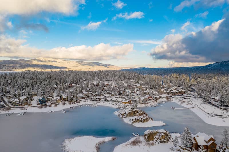 Snow-covered town around frozen Big Bear Lake