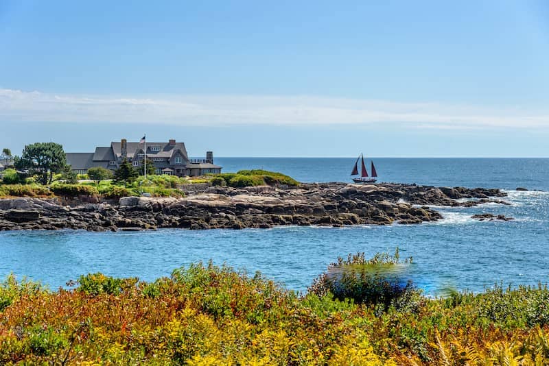 Walker’s Point in Kennebunkport, Maine with sailboat off coast