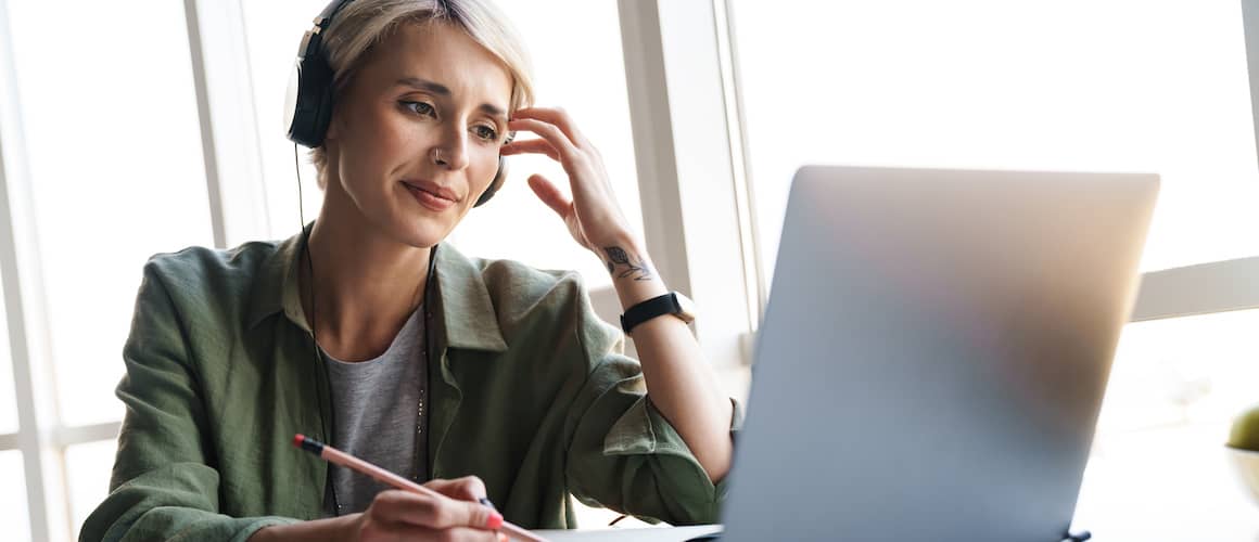 https://www.rocketmortgage.com/resources-cmsassets/RocketMortgage.com/Article_Images/Stock-Woman-With-Headphones-On-Computer-AdobeStock446620530%20copy.jpg